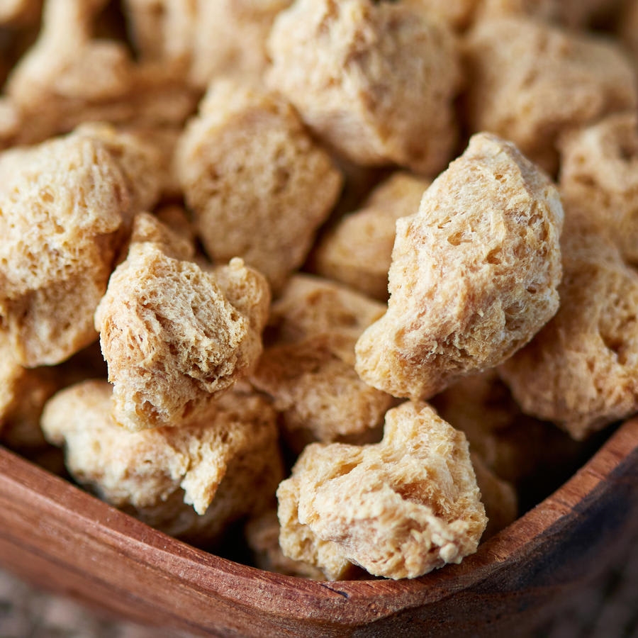 Raw soya chunks, soy meat for vegans in wooden bowl